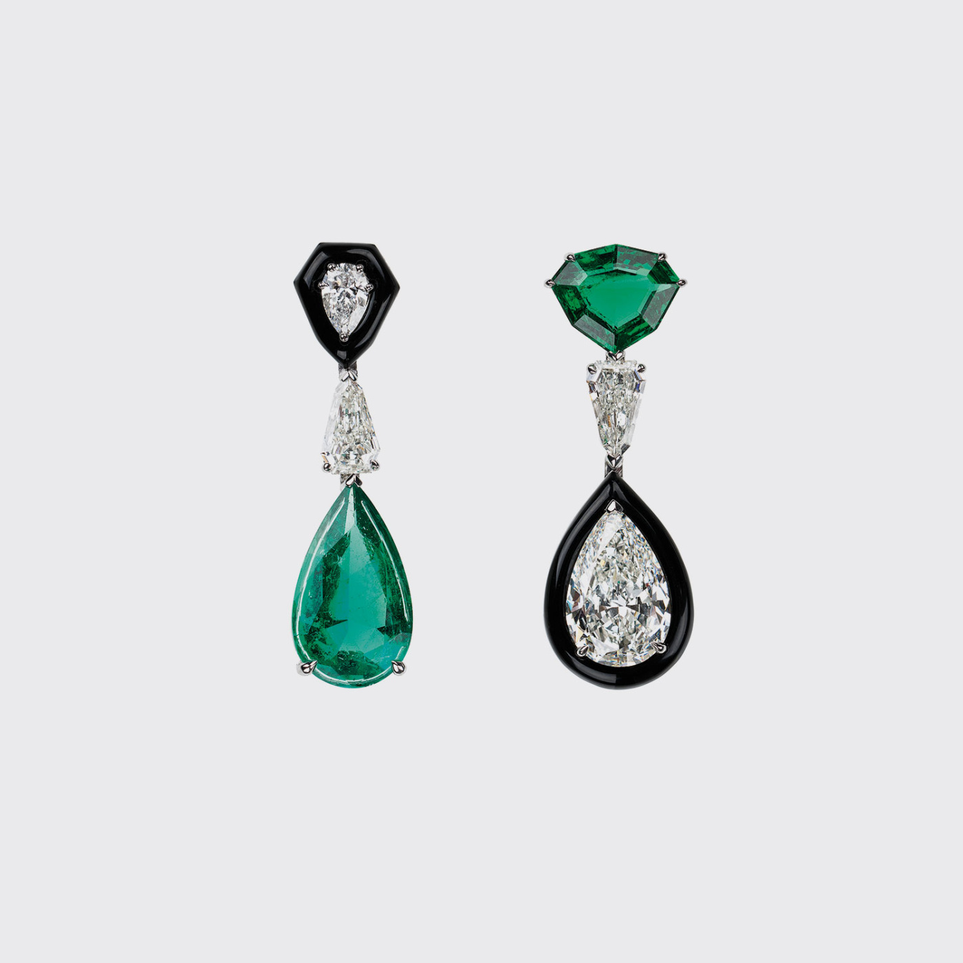 White gold mismatched earrings with emeralds and white diamonds and black enamel