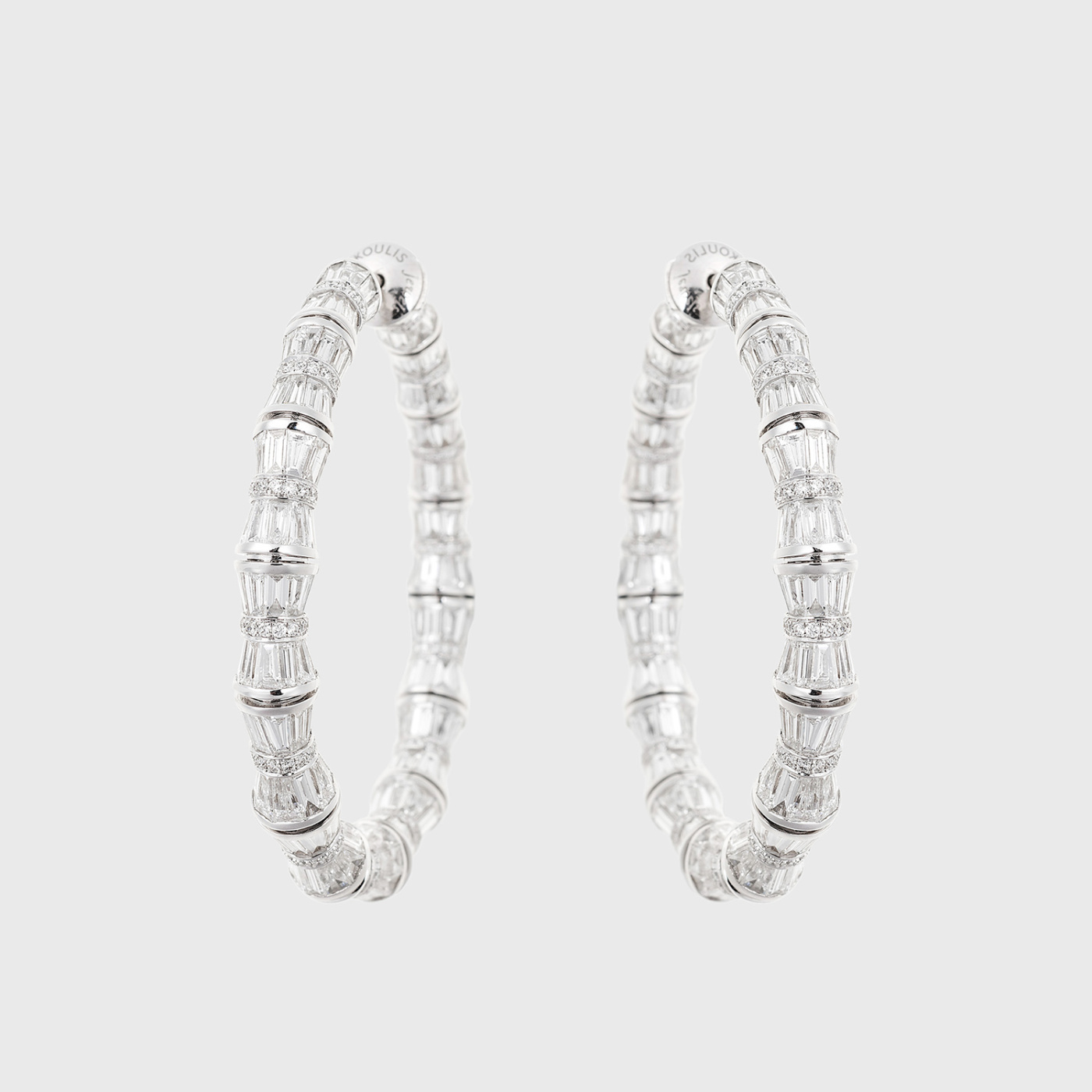 White gold hoop earrings with tapered baguette and round white diamonds